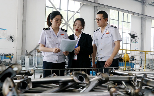 巫溪縣稅務(wù)局工作人員到企業(yè)輔導(dǎo)組合式稅費(fèi)支持政策。趙靜攝