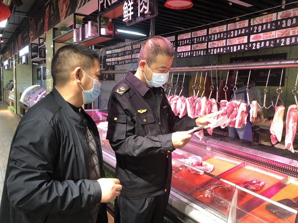 九龍坡區(qū)市場監(jiān)管局執(zhí)法人員檢查超市肉制品質(zhì)量。