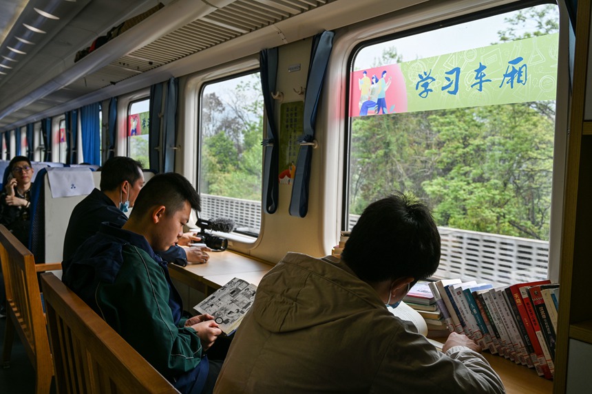 搭乘火車(chē)的旅客正在閱讀。鐘潔攝