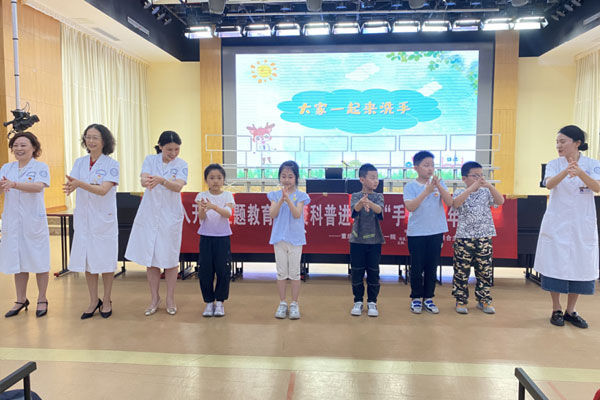 醫(yī)務人員帶領(lǐng)小朋友共同演示正確洗手步驟。劉林杰攝