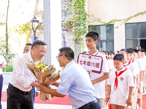 渝北區(qū)委教育工委書記、區(qū)教委主任吳云斌（左一）與黃炎培中學(xué)師生。黃炎培中學(xué)供圖