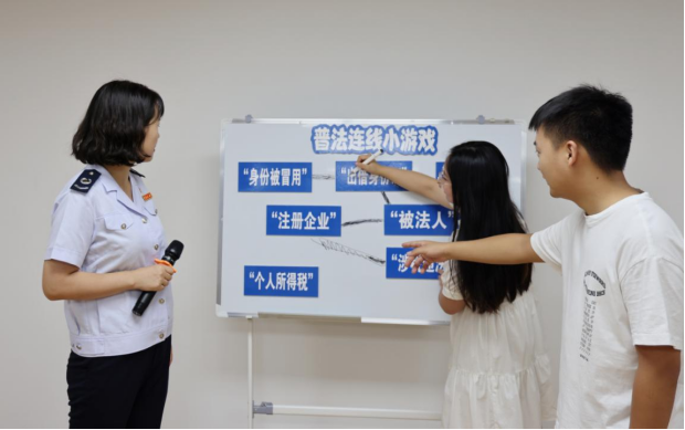 重慶市稅務局第七稽查局稅務人員帶領長江師范學院大學生玩稅收普法連線小游戲。何冰翊攝