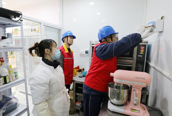 國網重慶市南供電公司員工來到烘焙操作間為客戶檢查用電安全。諶雅夢攝