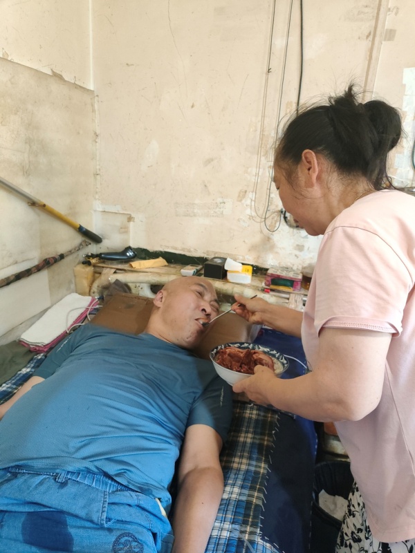 莫正容給楊忠友喂飯。荔枝街道供圖