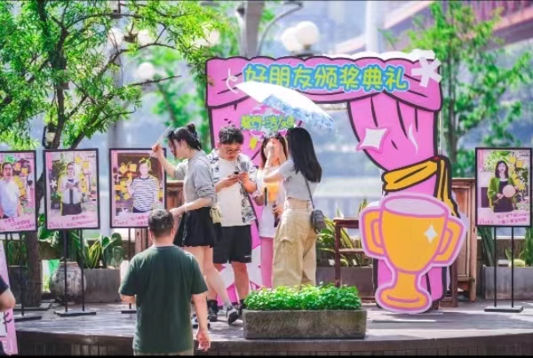 游客們?cè)凇邦C獎(jiǎng)典禮”現(xiàn)場(chǎng)拍照。龍門浩老街供圖